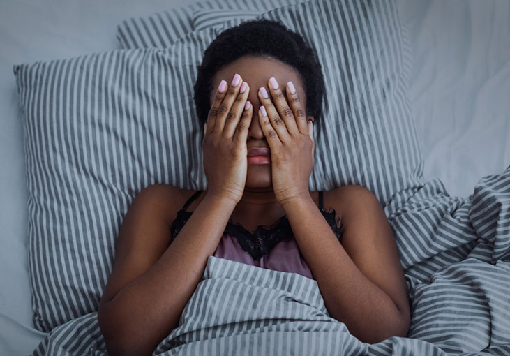 Woman struggling to sleep due to insomnia 