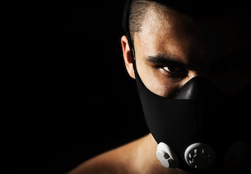Person wearing a Pro Mask to optimize aerobic training and military performance  