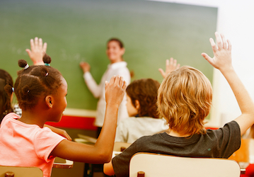 Kids raising their hands in classroom highlight total force fitness strategies for managing ADHD and boosting performance  