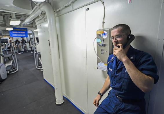 Deployed Service Member calls home to maintain military wellness and Total Force Fitness   U S  Navy photo by Mass Communicat