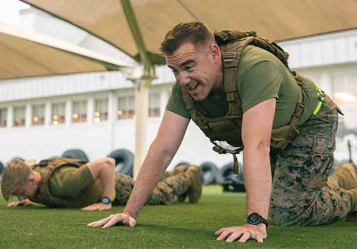 Two Marines doing a pushup