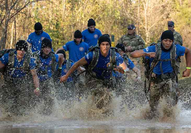 men running through water