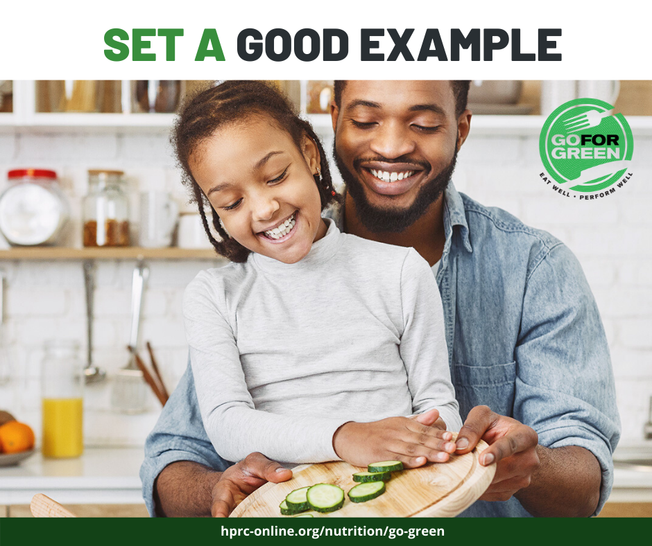 Set a good example. Father and daughter with healthy food. Go for Green logo. hprc-online.org/nutrition/go-green