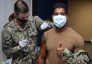 Navy soldier provides flu vaccination to increase resilience and improve performance optimization and injury prevention   U S