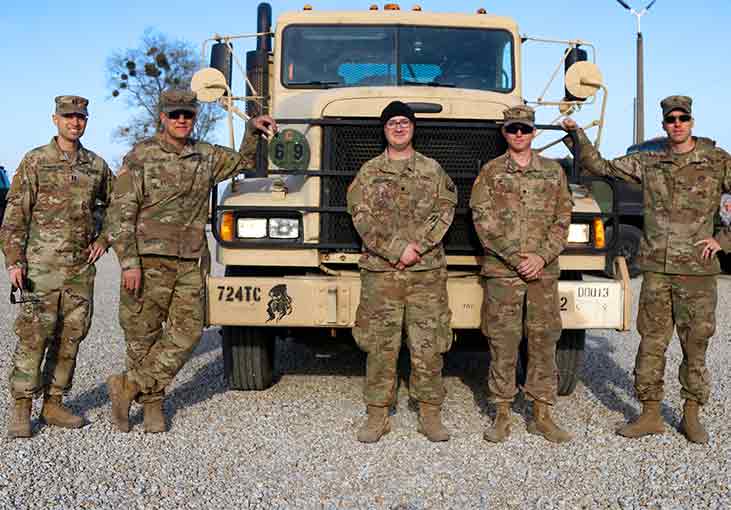 Army men in front of truck