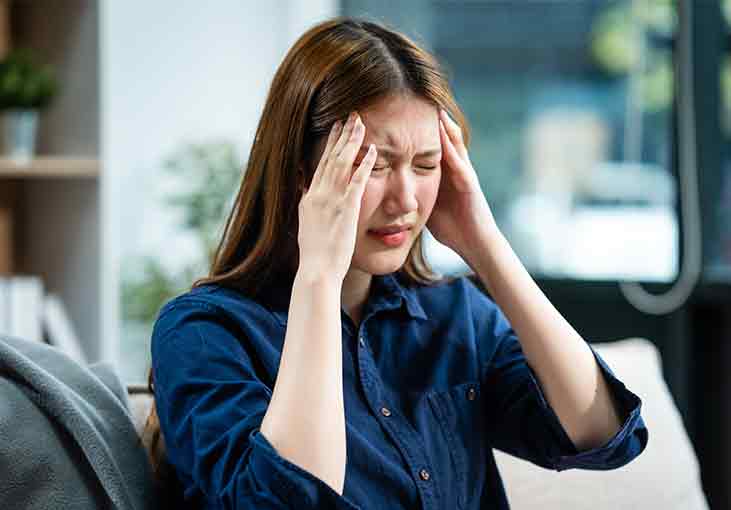 woman in distress rubbing her head