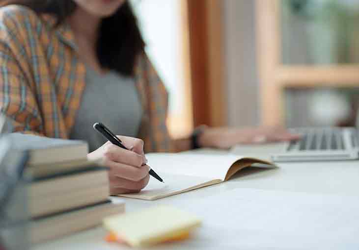 Person writing on paper